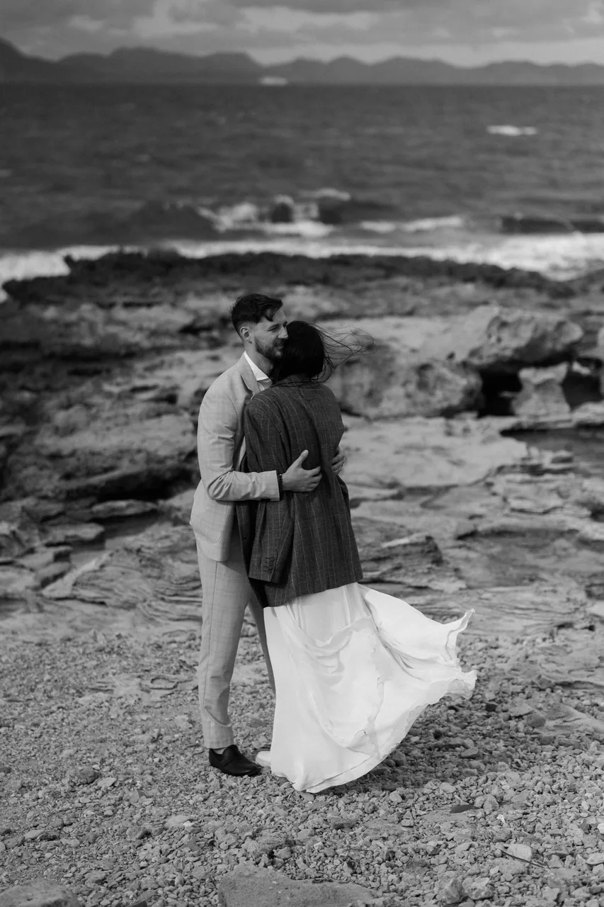 A wedding dress moving in the sea wind, in black and white