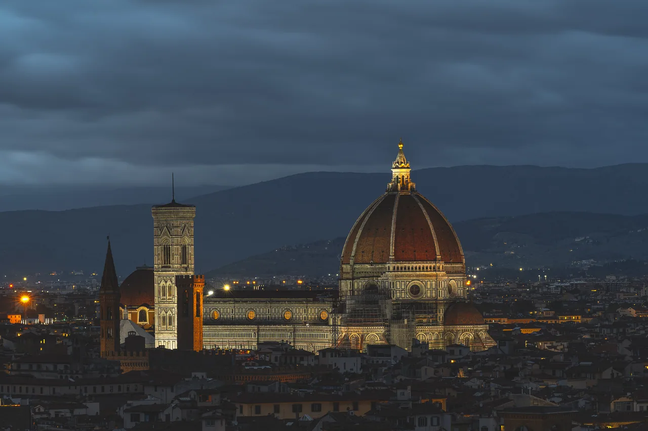 Florence cathedral dome rising above the city at dusk