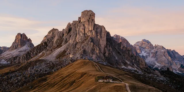 Jagged Dolomites peaks above green meadows in northern Italy