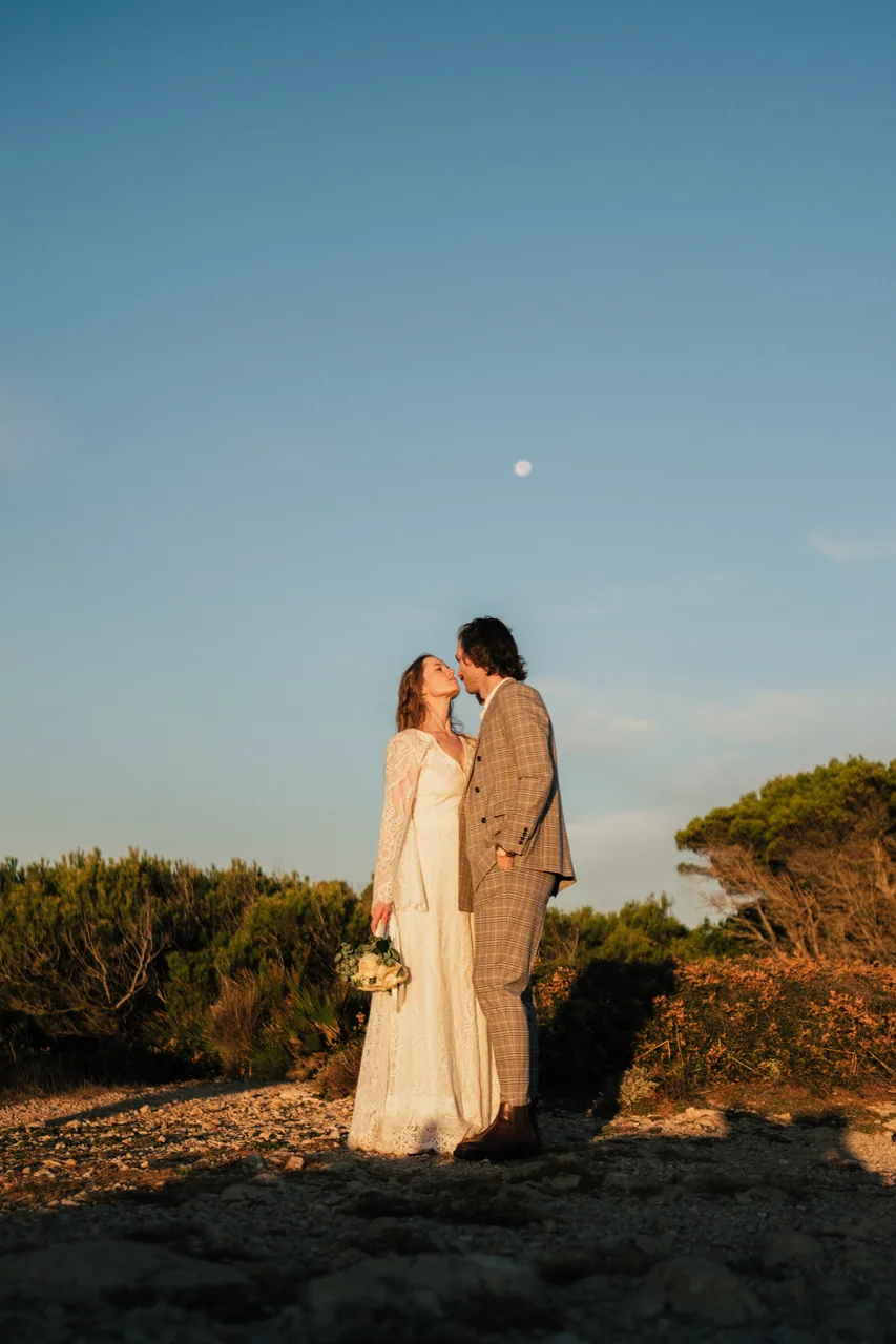 A couple together on a clifftop in soft evening light