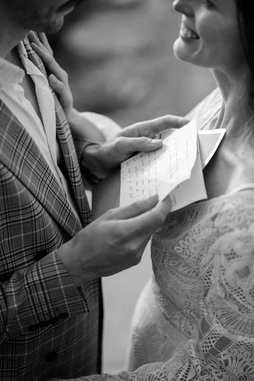 Reading handwritten vows, in black and white