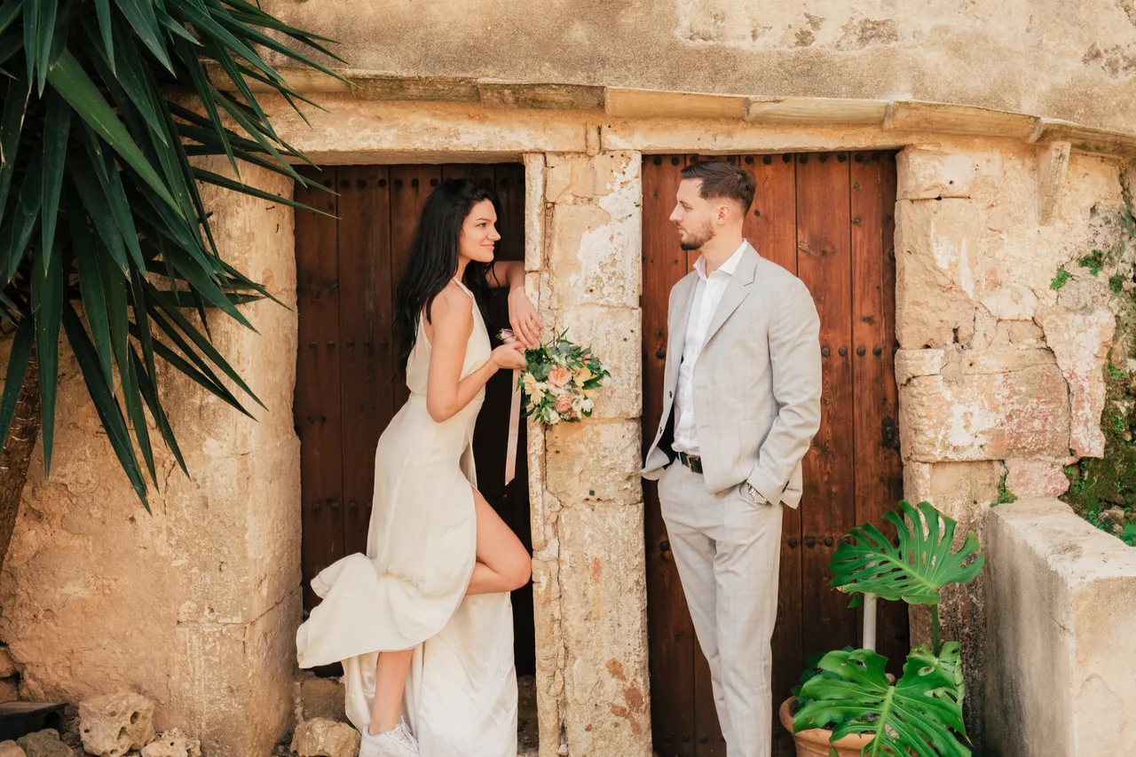 A couple framed by an old stone doorway